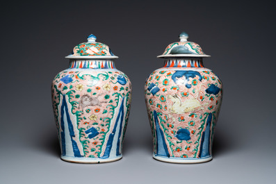 A pair of Chinese wucai 'galloping horses' vases and covers, Transitional period