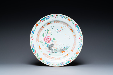 A Chinese famille rose 'cranes' dish and four armorial plates, Qianlong