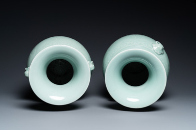 A pair of Chinese monochrome celadon vases with underglaze design on wooden stands, Qianlong mark, 18/19th C.