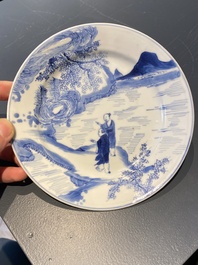 A Chinese blue and white plate with two men in a landscape, Kangxi