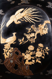 A large Japanese wooden screen with a central gilt-lacquered and ivory-inlaid panel, Meiji