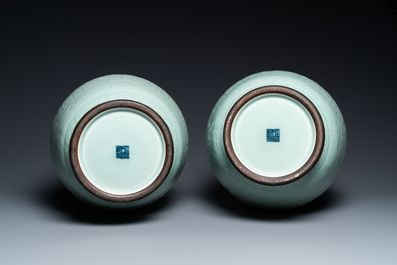 A pair of Chinese monochrome celadon vases with underglaze design on wooden stands, Qianlong mark, 18/19th C.