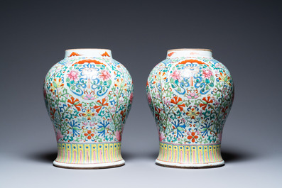 A pair of Chinese famille rose vases with wooden covers and stands, 19th C.