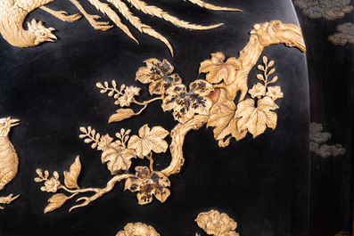 A large Japanese wooden screen with a central gilt-lacquered and ivory-inlaid panel, Meiji