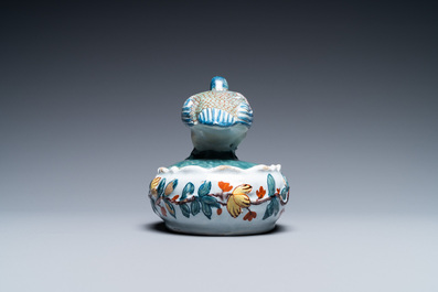 A polychrome Dutch Delft butter tub and cover with a bird, 18th C.