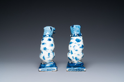A pair of Dutch Delft blue and white seated dogs, 18th C.