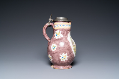 A polychrome Brussels faience ewer with a wheelwright, 18th C.