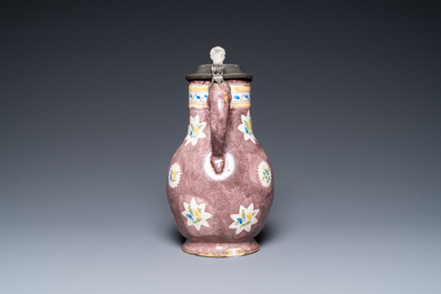 A polychrome Brussels faience ewer with a wheelwright, 18th C.