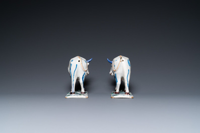 A pair of polychrome Dutch Delft cows on bases with frogs, 18th C.