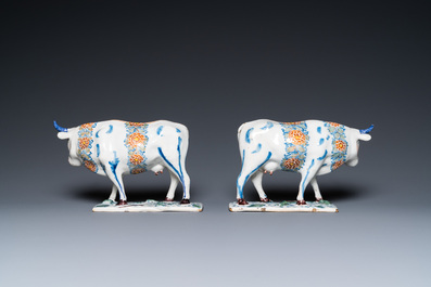 A pair of polychrome Dutch Delft cows on bases with frogs, 18th C.