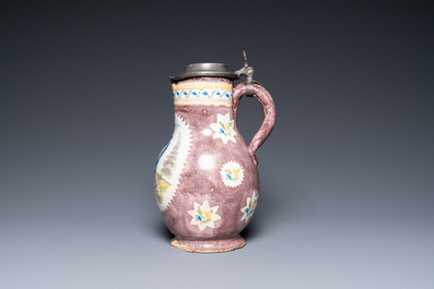 A polychrome Brussels faience ewer with a wheelwright, 18th C.