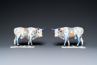 A pair of polychrome Dutch Delft cows on bases with frogs, 18th C.