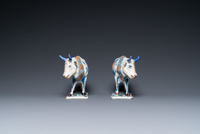 A pair of polychrome Dutch Delft cows on bases with frogs, 18th C.