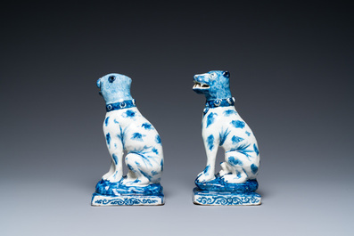 A pair of Dutch Delft blue and white seated dogs, 18th C.