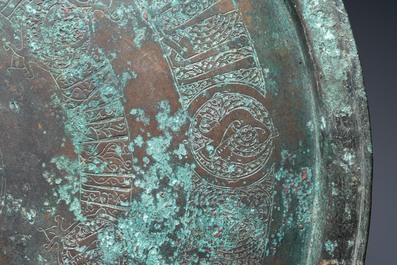 A large Seljuk bronze dish with engraved birds and Kufic inscriptions, Iran, 12/14th C.