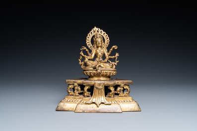 A Sino-Tibetan gilt bronze figure of Ushnishavijaya on a lotus throne with an inscription on the back, 18th C.