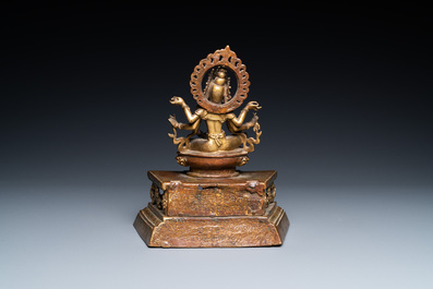 A Sino-Tibetan gilt bronze figure of Ushnishavijaya on a lotus throne with an inscription on the back, 18th C.