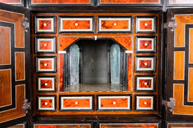 A tortoise veneer, gilt copper, ebony and ebonised wooden mirrored interior cabinet on stand, Antwerp, 17th C.