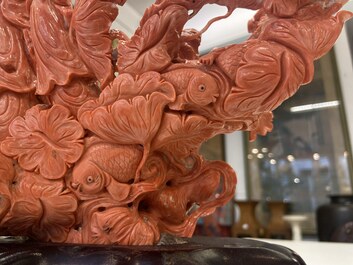 A large Chinese carved red coral group with two ladies surrounded by birds, fish and flowers, 19th C.