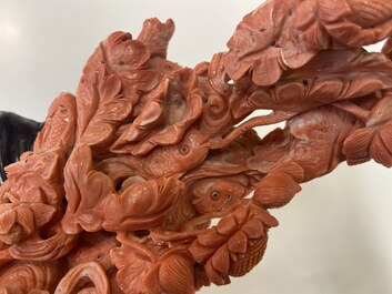 A large Chinese carved red coral group with two ladies surrounded by birds, fish and flowers, 19th C.
