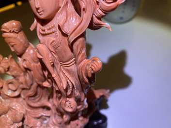 A large Chinese carved red coral group with two ladies surrounded by birds, fish and flowers, 19th C.