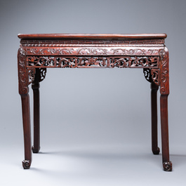 A Chinese rectangular carved wooden table with marble top, 19th C.