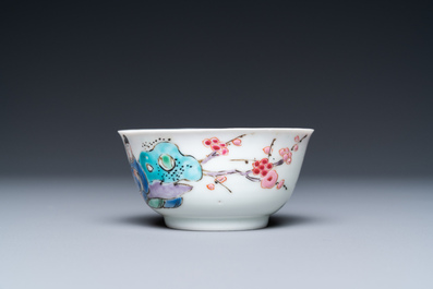 A Chinese famille rose cup and saucer with a couple on a terrace, Qianlong