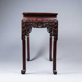 A Chinese rectangular carved wooden table with marble top, 19th C.