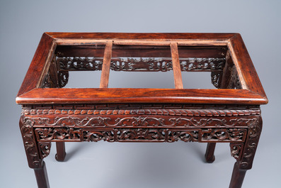 A Chinese rectangular carved wooden table with marble top, 19th C.