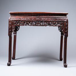 A Chinese rectangular carved wooden table with marble top, 19th C.