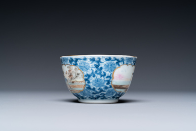 A Chinese famille rose blue and white lotus-scroll-ground 'fish-seller' cup and saucer, Qianlong