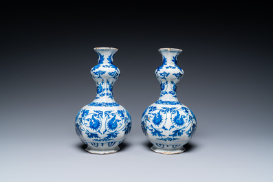 A pair of Dutch Delft blue and white 'garlic head' vases with lotus design, late 17th C.