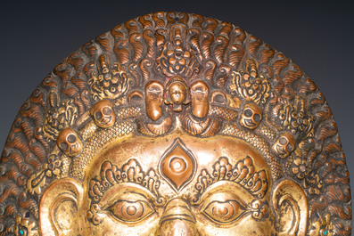 A large Tibetan gilt copper repouss&eacute; mask of Bhairava, Tibet or Nepal, 19th C.