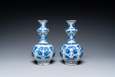 A pair of Dutch Delft blue and white 'garlic head' vases with lotus design, late 17th C.