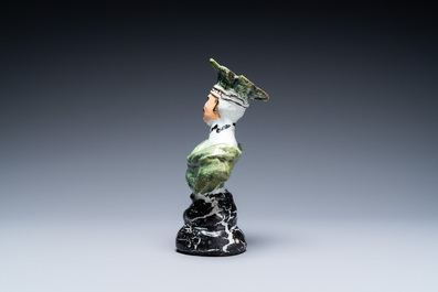 A polychrome French faience candlestick in the shape of a man, 18th C.