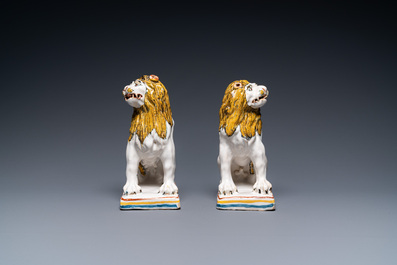 A pair of polychrome French faience lions, Rouen, 1st half 18th C.