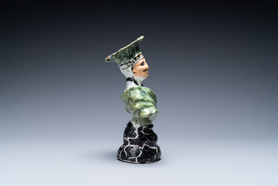 A polychrome French faience candlestick in the shape of a man, 18th C.