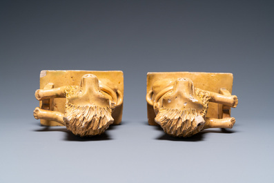 A pair of Flemish or North-French pottery lions, signed and dated 1865