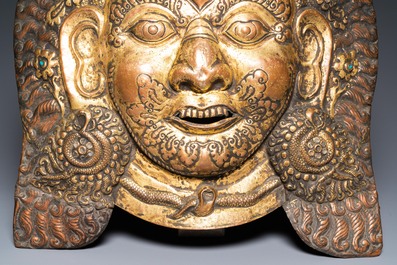 A large Tibetan gilt copper repouss&eacute; mask of Bhairava, Tibet or Nepal, 19th C.