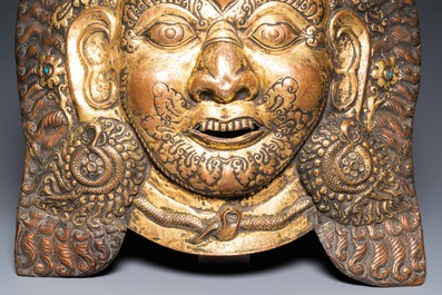 A large Tibetan gilt copper repouss&eacute; mask of Bhairava, Tibet or Nepal, 19th C.