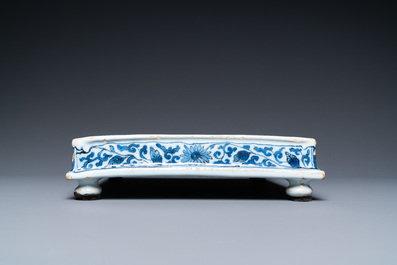 A Dutch Delft blue and white square footed tray on ball feet with chinoiserie design, late 17th C.