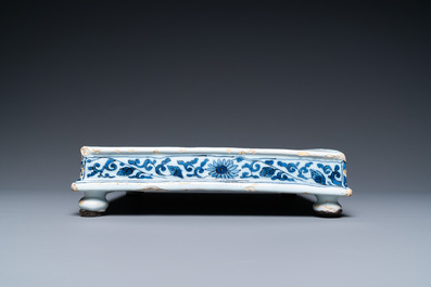 A Dutch Delft blue and white square footed tray on ball feet with chinoiserie design, late 17th C.