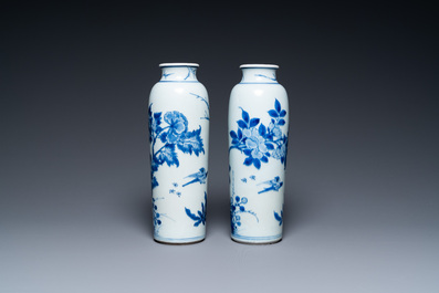 A pair of Chinese blue and white rouleau vases with birds among blossoming branches, Transitional period
