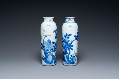 A pair of Chinese blue and white rouleau vases with birds among blossoming branches, Transitional period