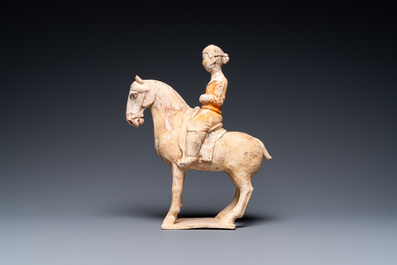 A Chinese painted pottery 'lady on horseback' group, Tang