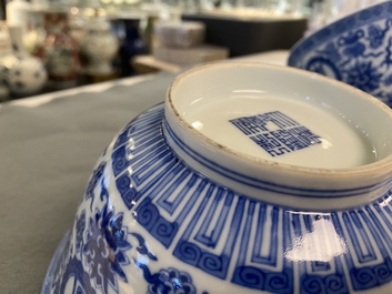 A pair of Chinese blue and white 'wan shou wu jiang' bowls, Qianlong mark and of the period