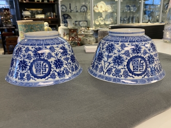 A pair of Chinese blue and white 'wan shou wu jiang' bowls, Qianlong mark and of the period