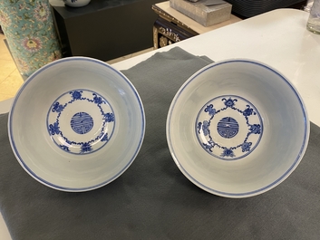 A pair of Chinese blue and white 'wan shou wu jiang' bowls, Qianlong mark and of the period