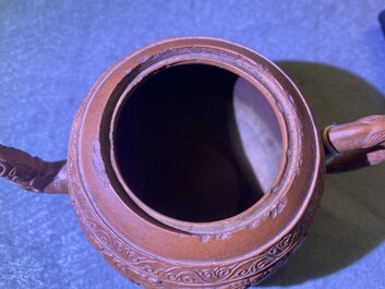 A Chinese Yixing stoneware teapot with boys among peony scrolls, Kangxi