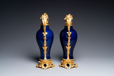 A pair of Chinese monochrome blue vases with gilt bronze ewer mounts, Qianlong and 19th C.